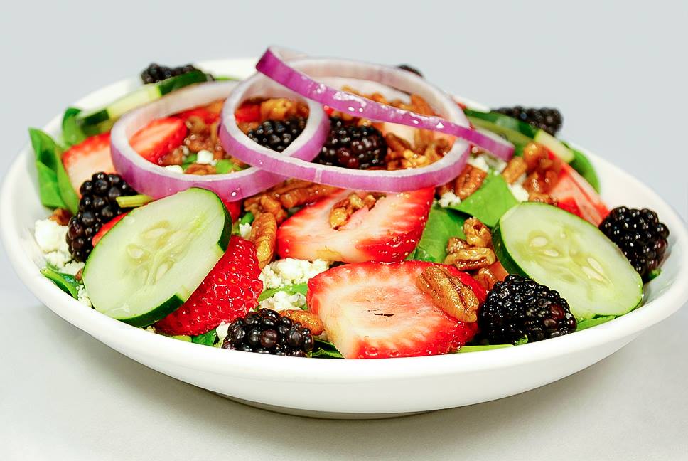 Spinach salad with blackberries, strawberries, feta, cucumber, red onions and walnuts